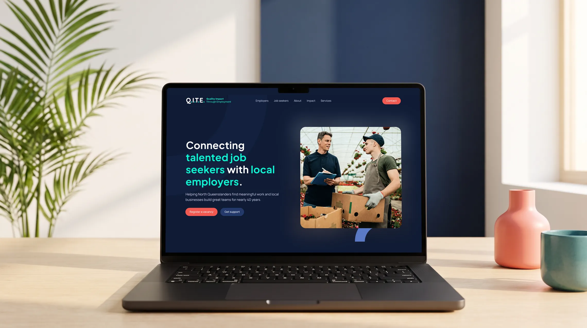 The new Q.I.T.E. website shown on a MacBook Pro